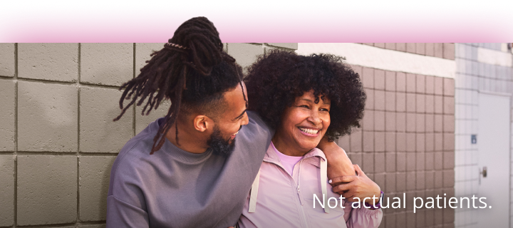 A man standing with a woman with his arm over her shoulder. Not actual patients. 